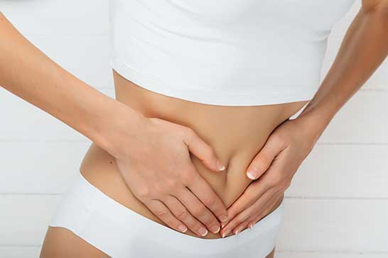 Digestive Matters - Woman with cramps holding stomach